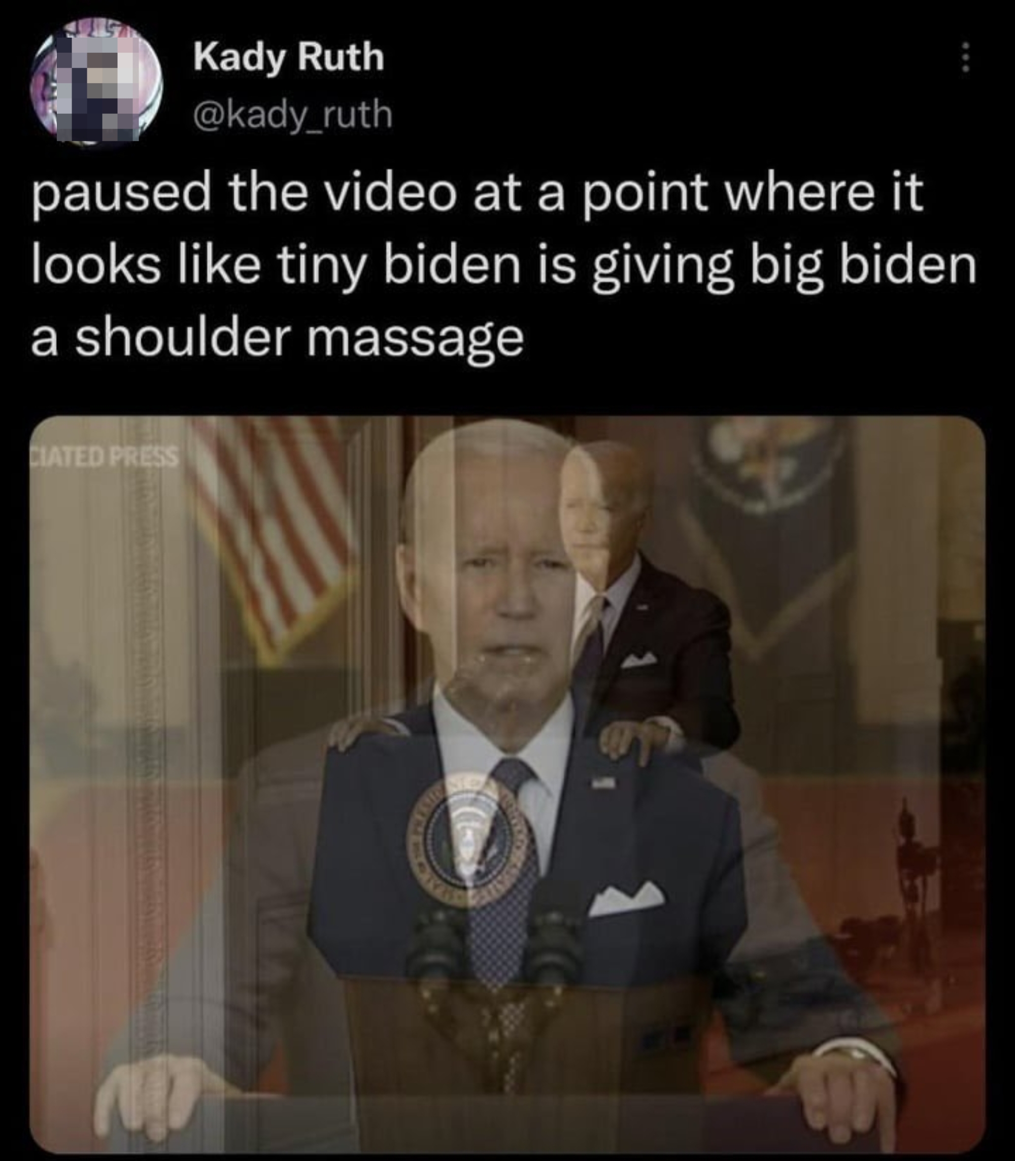 A paused video creates an amusing illusion of a small figure giving President Biden a shoulder massage