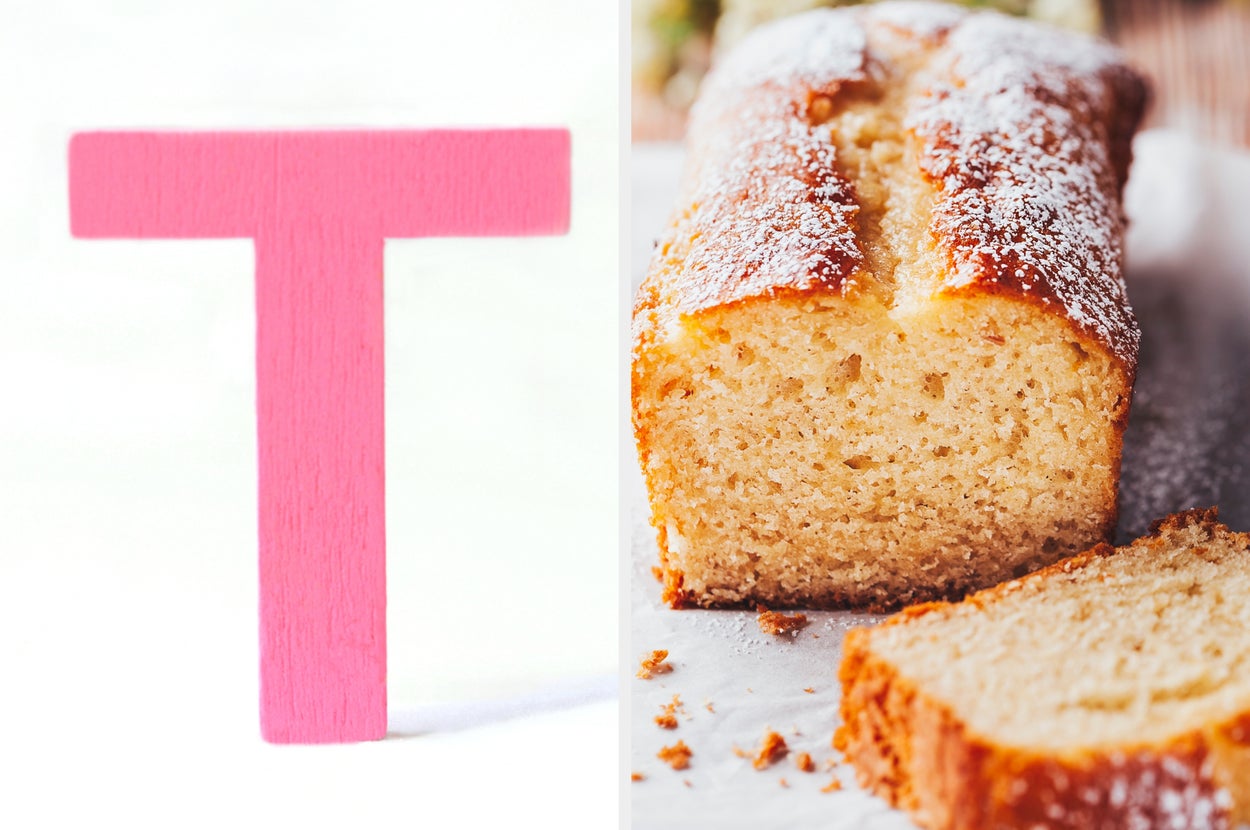 A wooden letter "T" stands next to a sliced loaf of pound cake dusted with powdered sugar