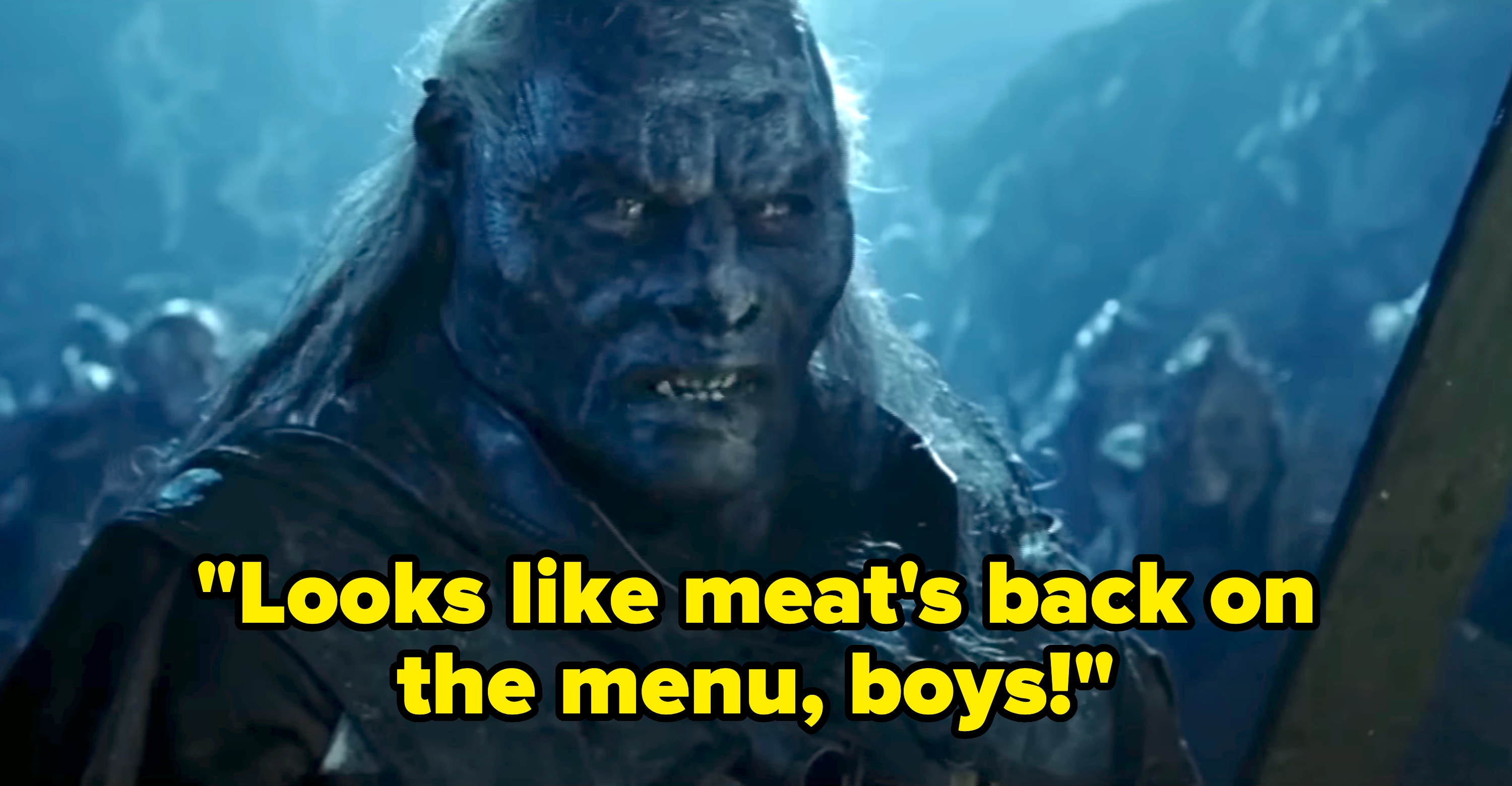 A fearsome orc character from a fantasy film, shown in a dramatic battle scene with an intense expression and rugged armor