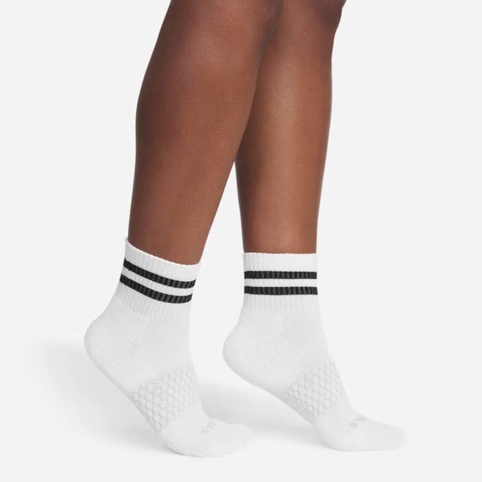 Model wearing achromatic socks with 2 achromatic stripes