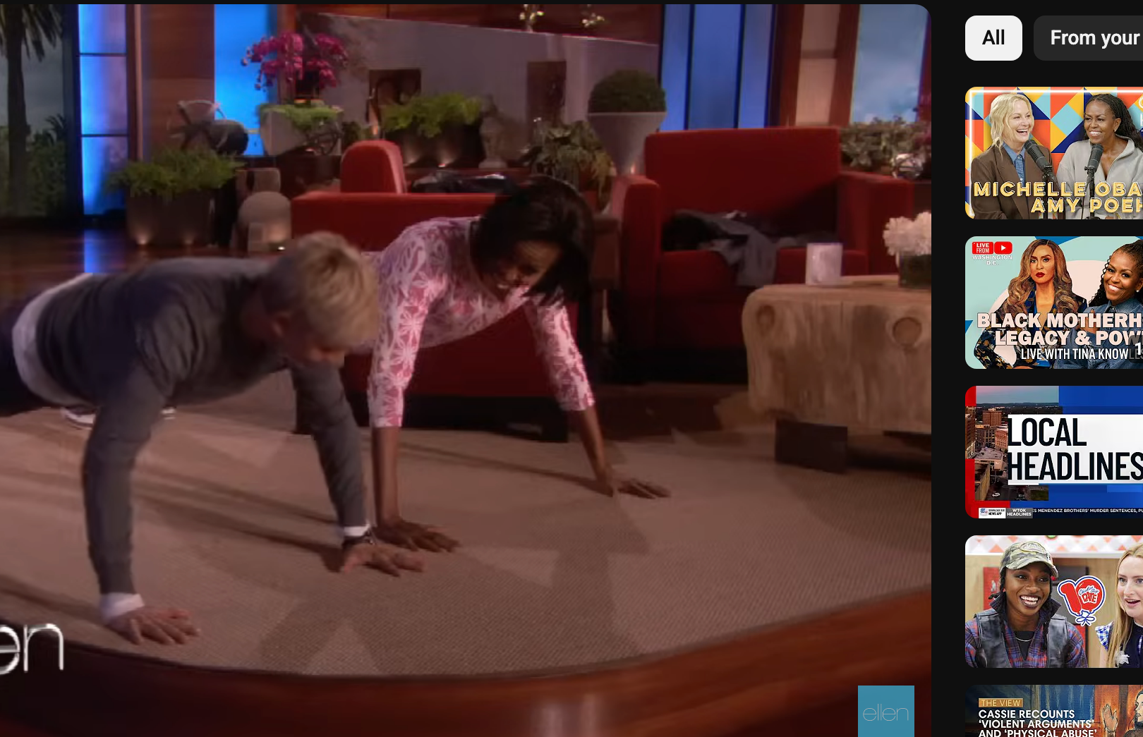 Michelle Obama and Ellen DeGeneres perform push-ups on a talk show stage in front of an audience