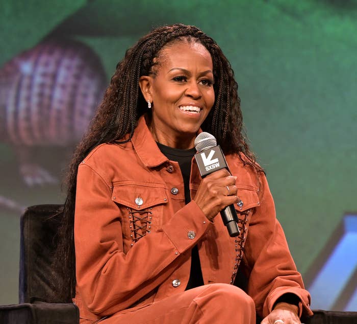 Michelle Obama on stage holding a microphone