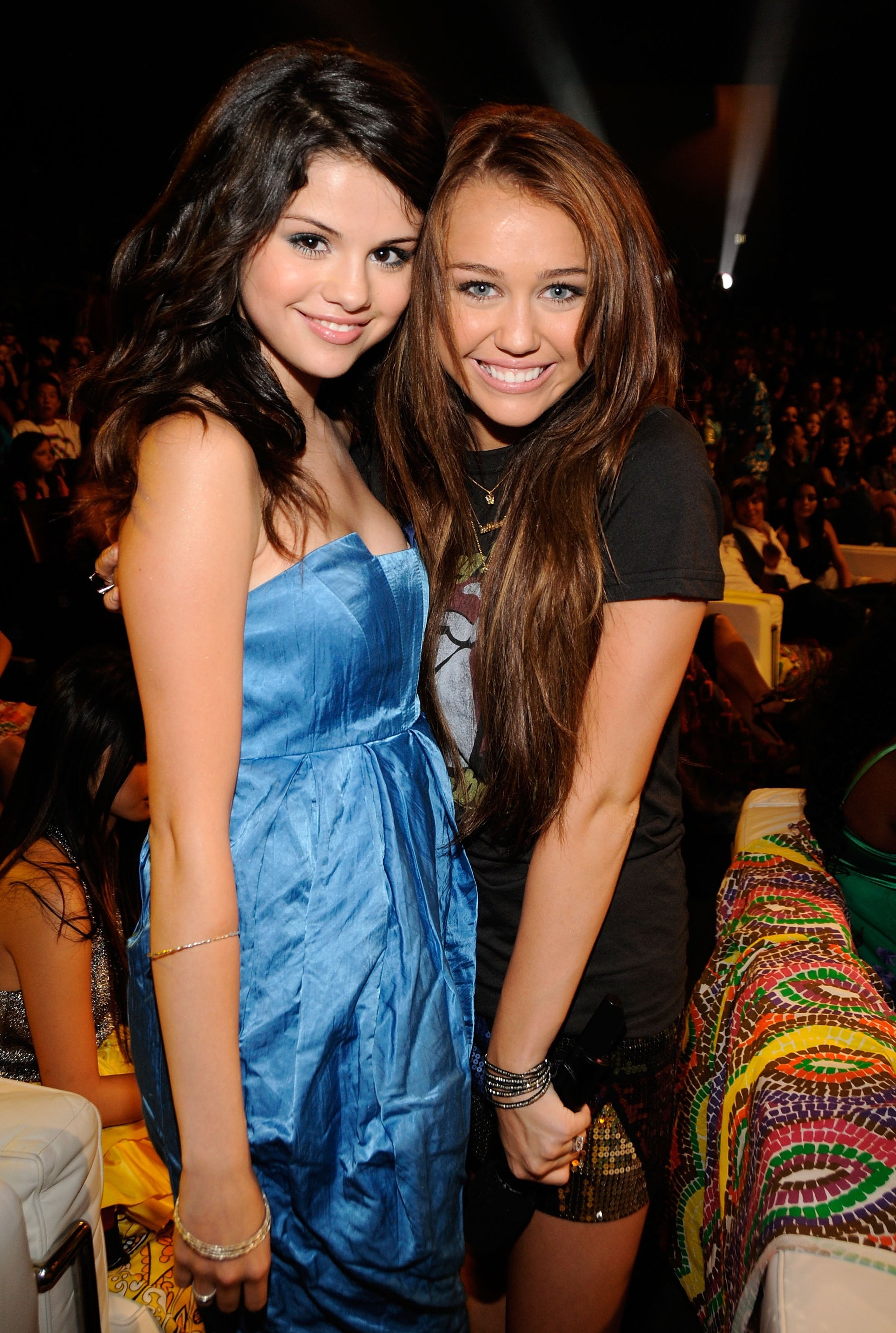 Selena Gomez and Miley Cyrus posing at an event