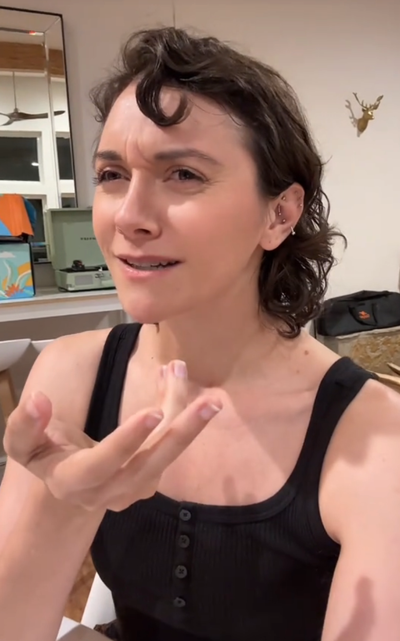 Alyson Stoner looking concerned, gesturing while talking in a TikTok