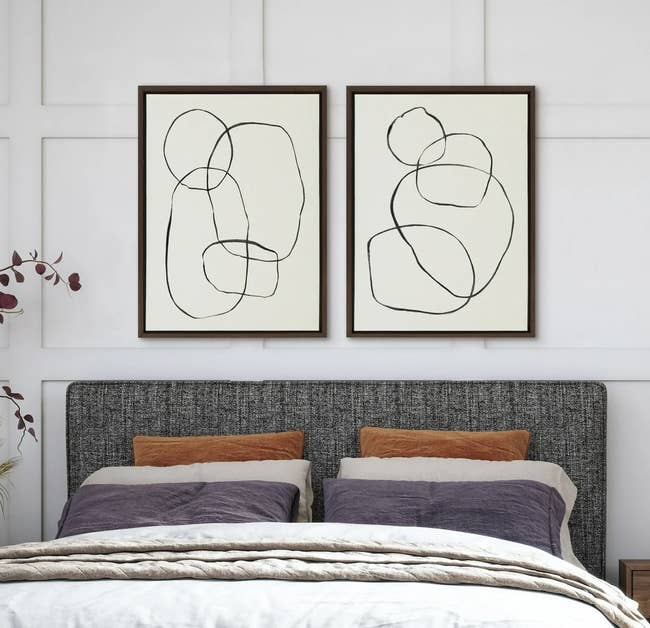 Bedroom with a modern, upholstered bed, abstract creation connected the wall, and a cozy seat astatine the foot. Nightstands with lamps flank the bed