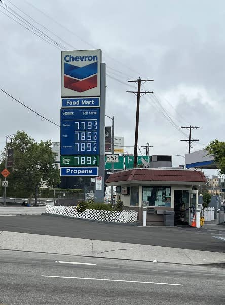 Gas station sign shows high prices: $7.79/gal for regular, $7.85/gal for plus, $7.89/gal for supreme