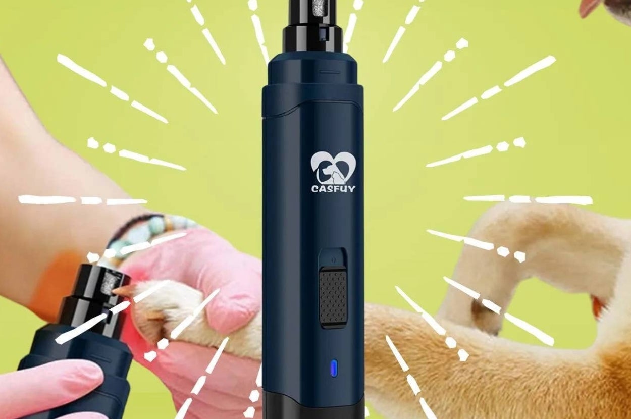 Electric pet nail grinder with a blue casing, held by a person in pink gloves, as a dog extends its paw
