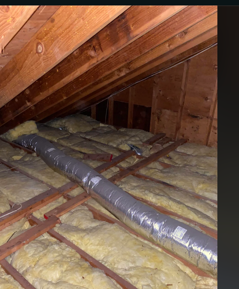 Image of attic with installed R30 unfaced fiberglass insulation between joists, viewed in a Reddit post about home insulation improvements