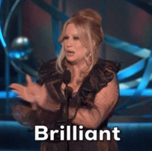 Person claps while speaking at an event; text over image reads "Brilliant."