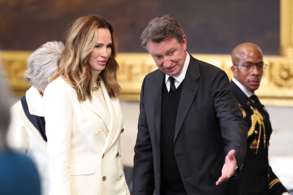 Former NHL player Wayne Gretzky in formal attire and his wife Janet Jones wearing a white blazer arrive for the Inauguration of Donald J. Trump in the U.S. Capitol Rotunda on January 20, 2025 in Washington, DC