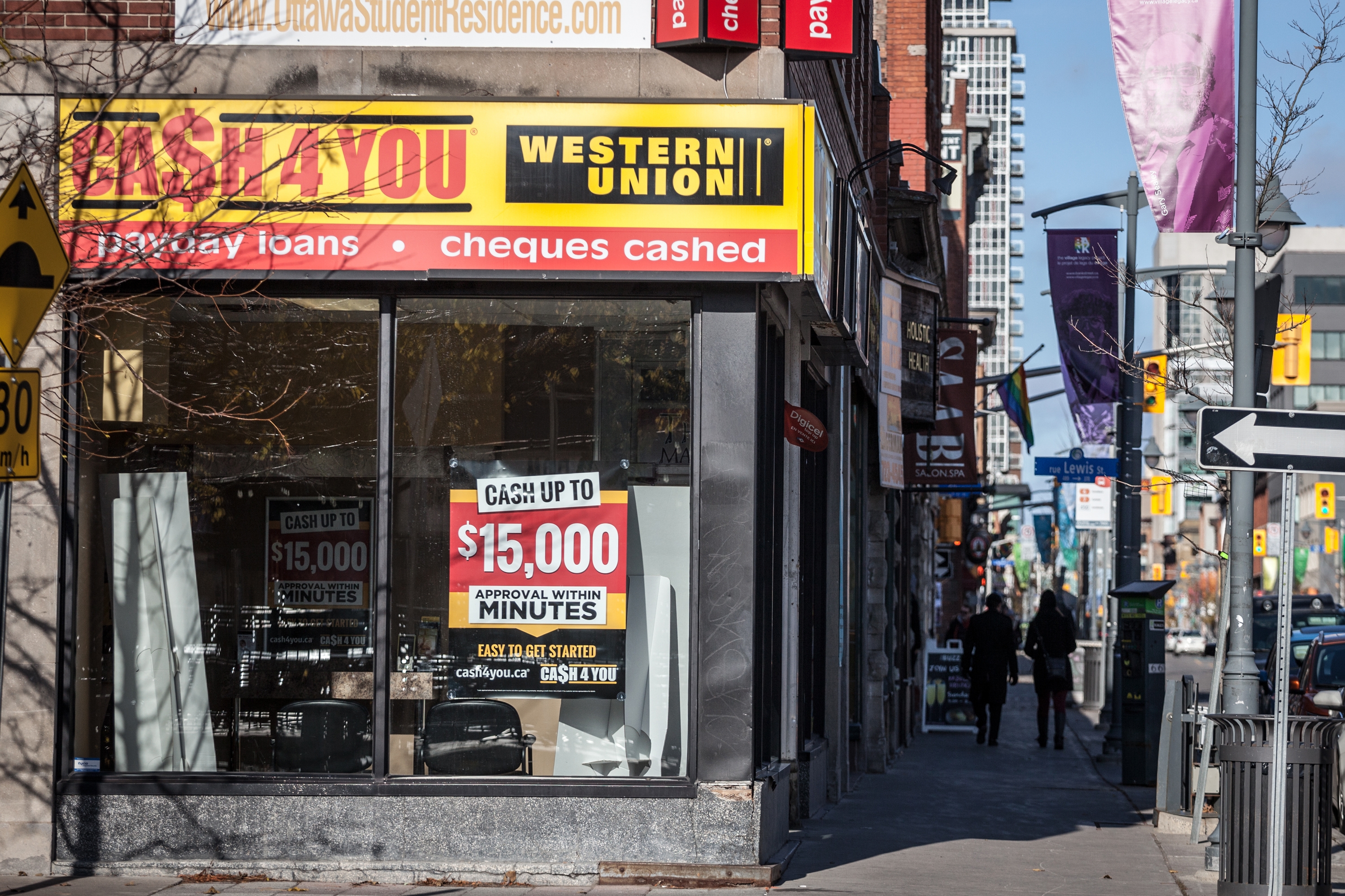 Storefront window advertises payday loans up to $15,000 with approval in minutes