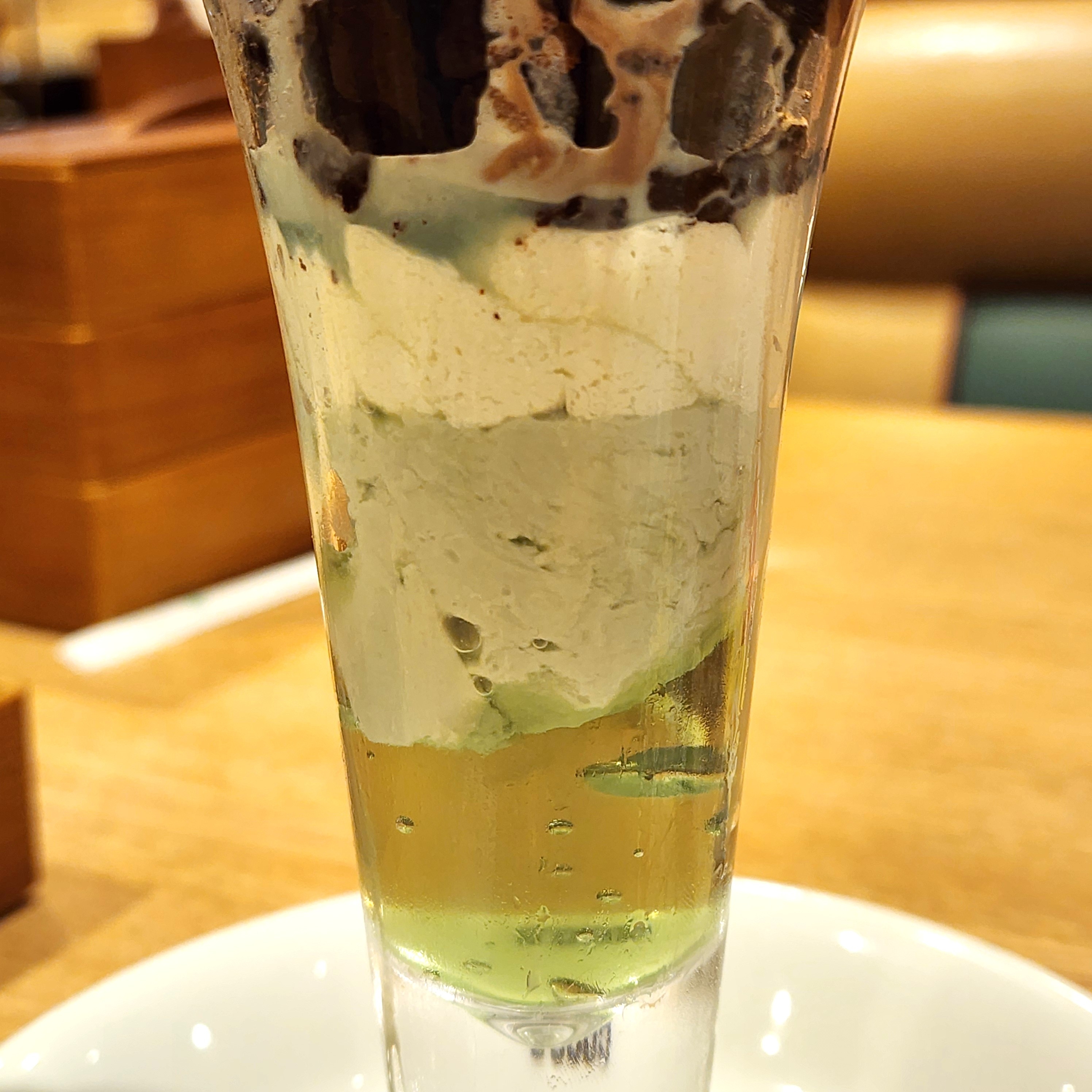 アイスクリームとゼリーが層になったデザートパフェがグラスに入っている。