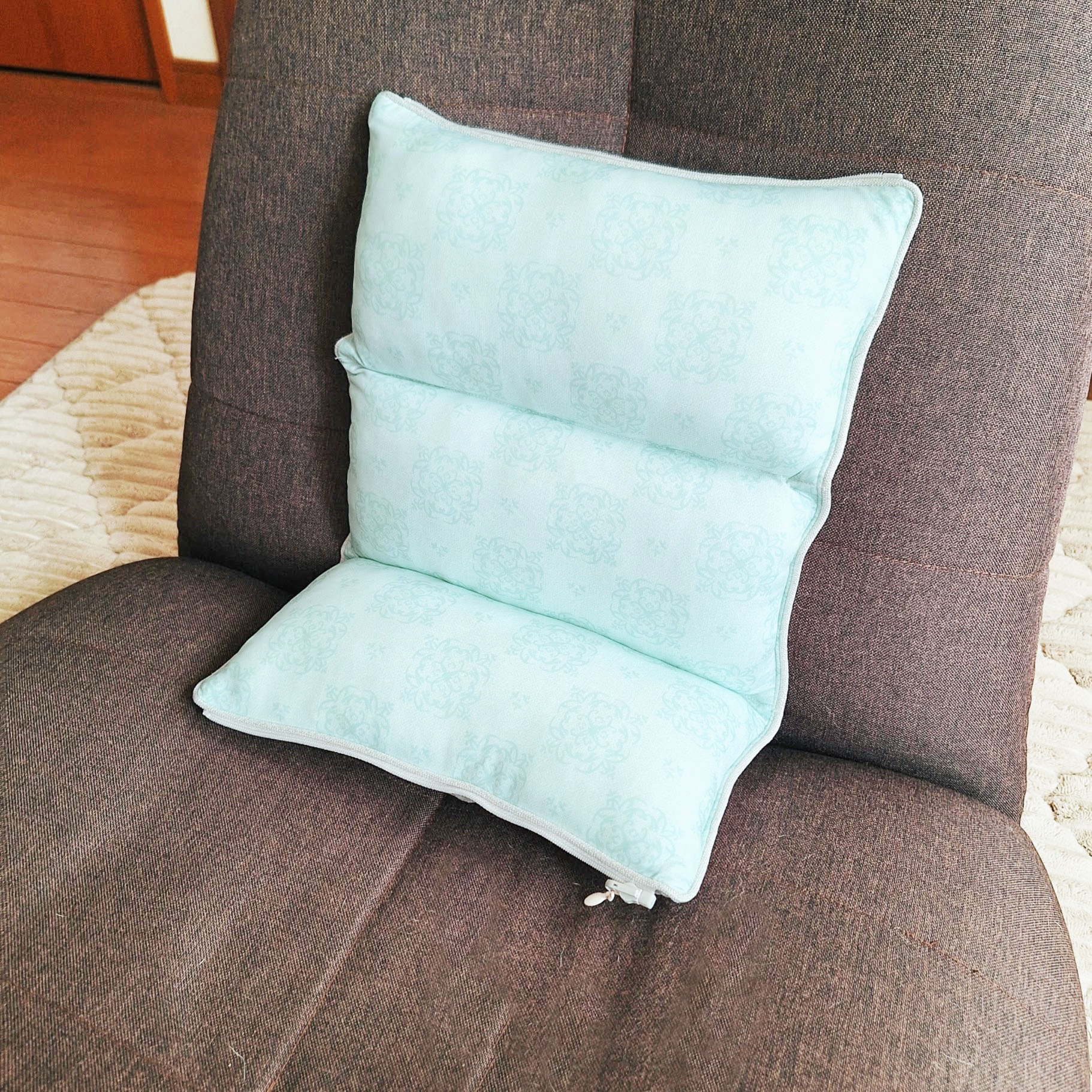 椅子の上に置かれたバックサポート用のクッション。柔らかそうで、快適さを提供するためにデザインされている。