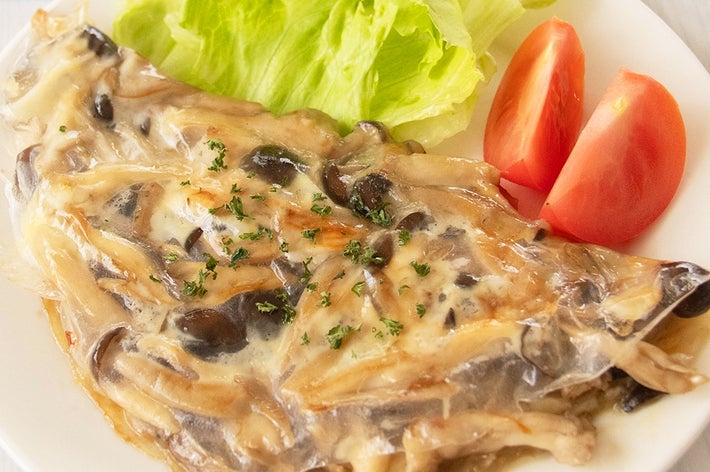 お皿に乗ったきのこのライスペーパーオムレツとレタス、トマトのサラダ。