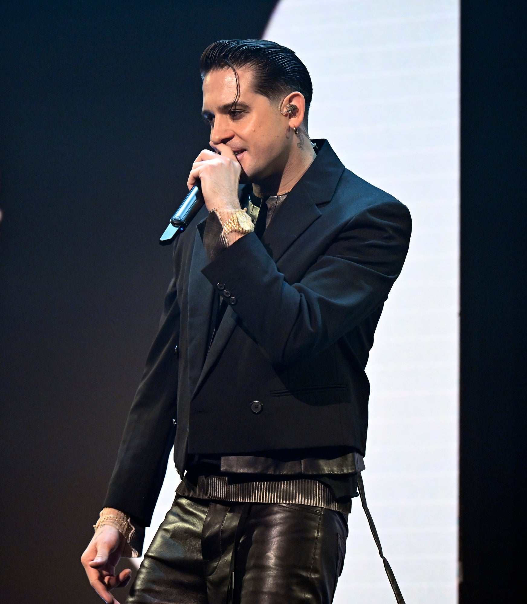 G-Eazysuit performing on stage with a microphone