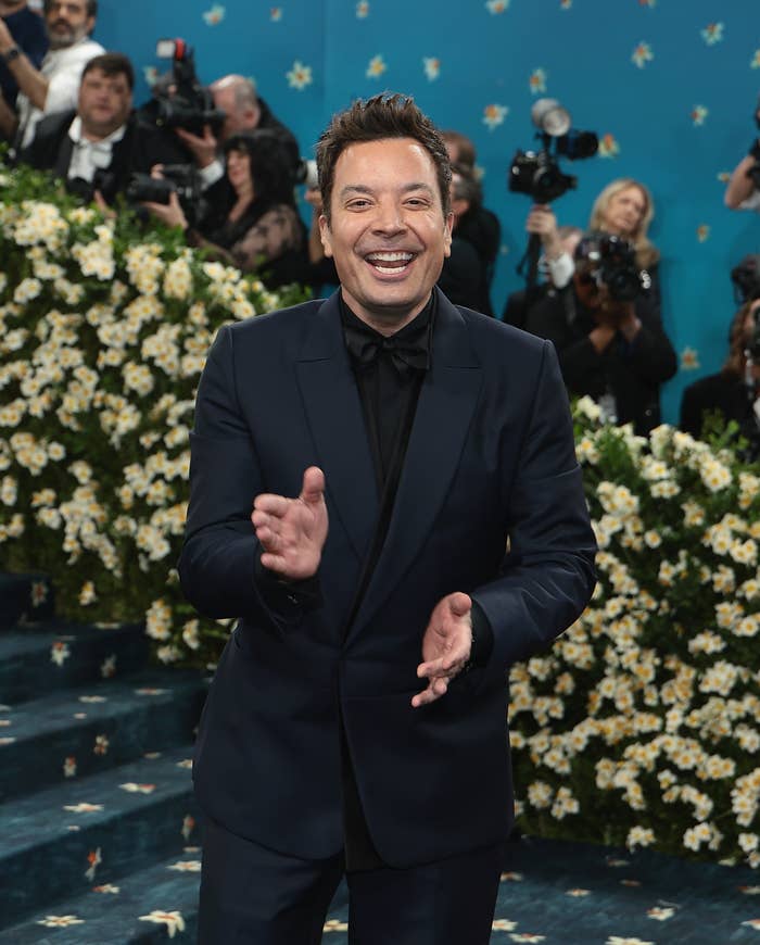 Jimmy Fallon laughing while clapping at the Met Gala