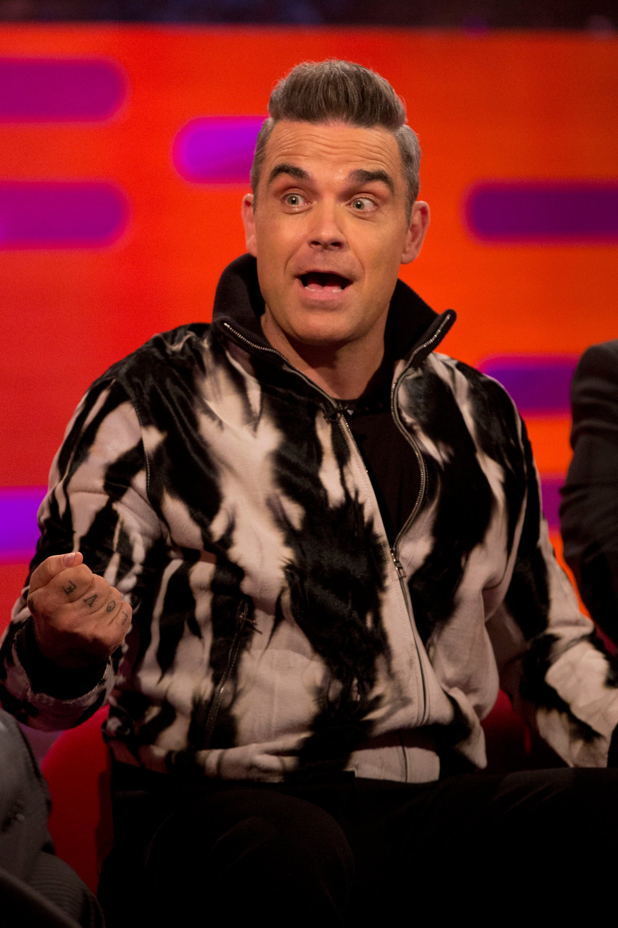 Robbie Williams on talk show set