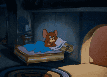 Animated mouse, Jerry, lies in bed under a blanket, appearing annoyed. He turns away, clutching a pillow, in a dimly lit room