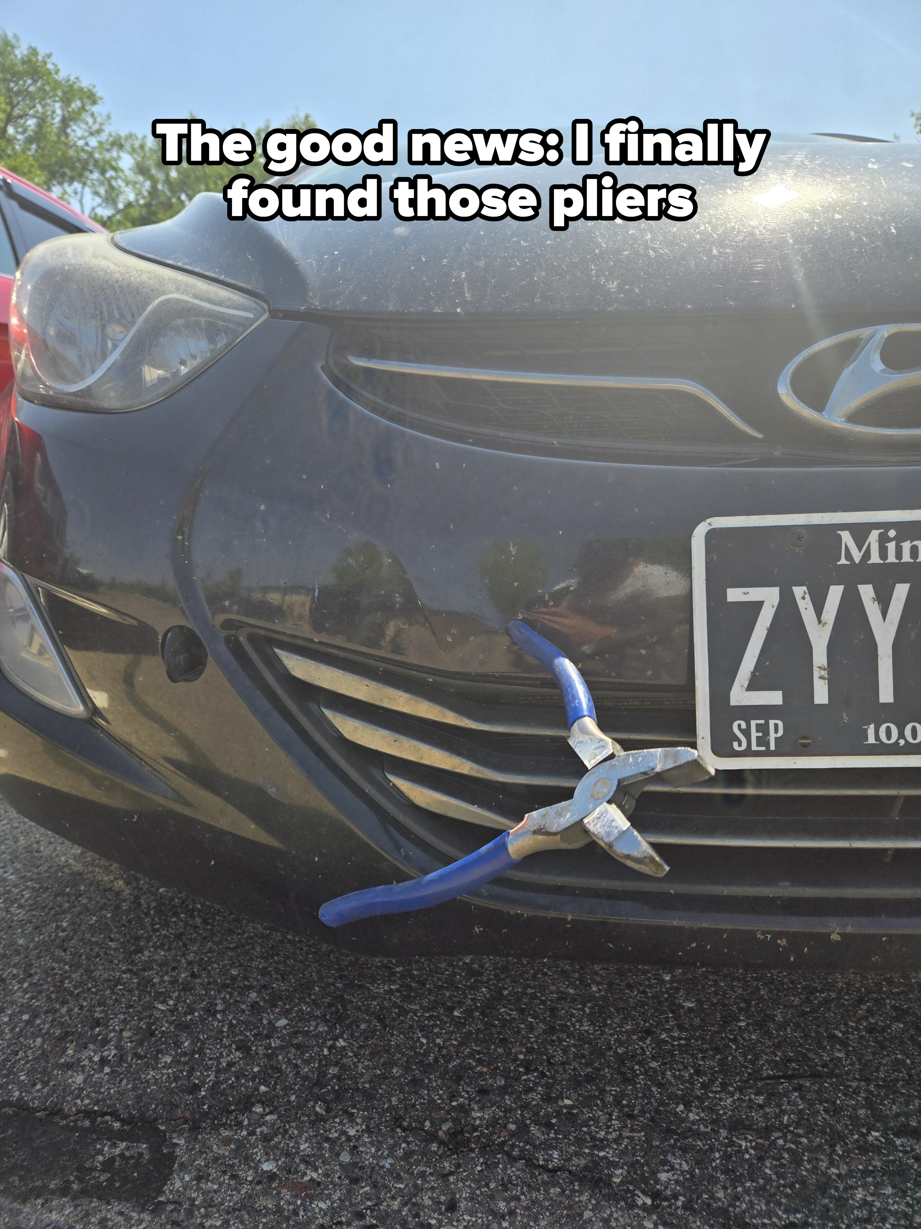 Car front with pliers stuck in the grille, Minnesota license plate visible