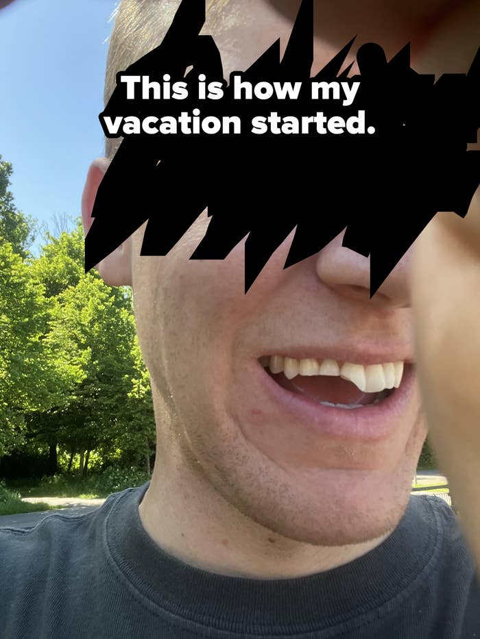 Person smiling outdoors, partially covering camera with hand