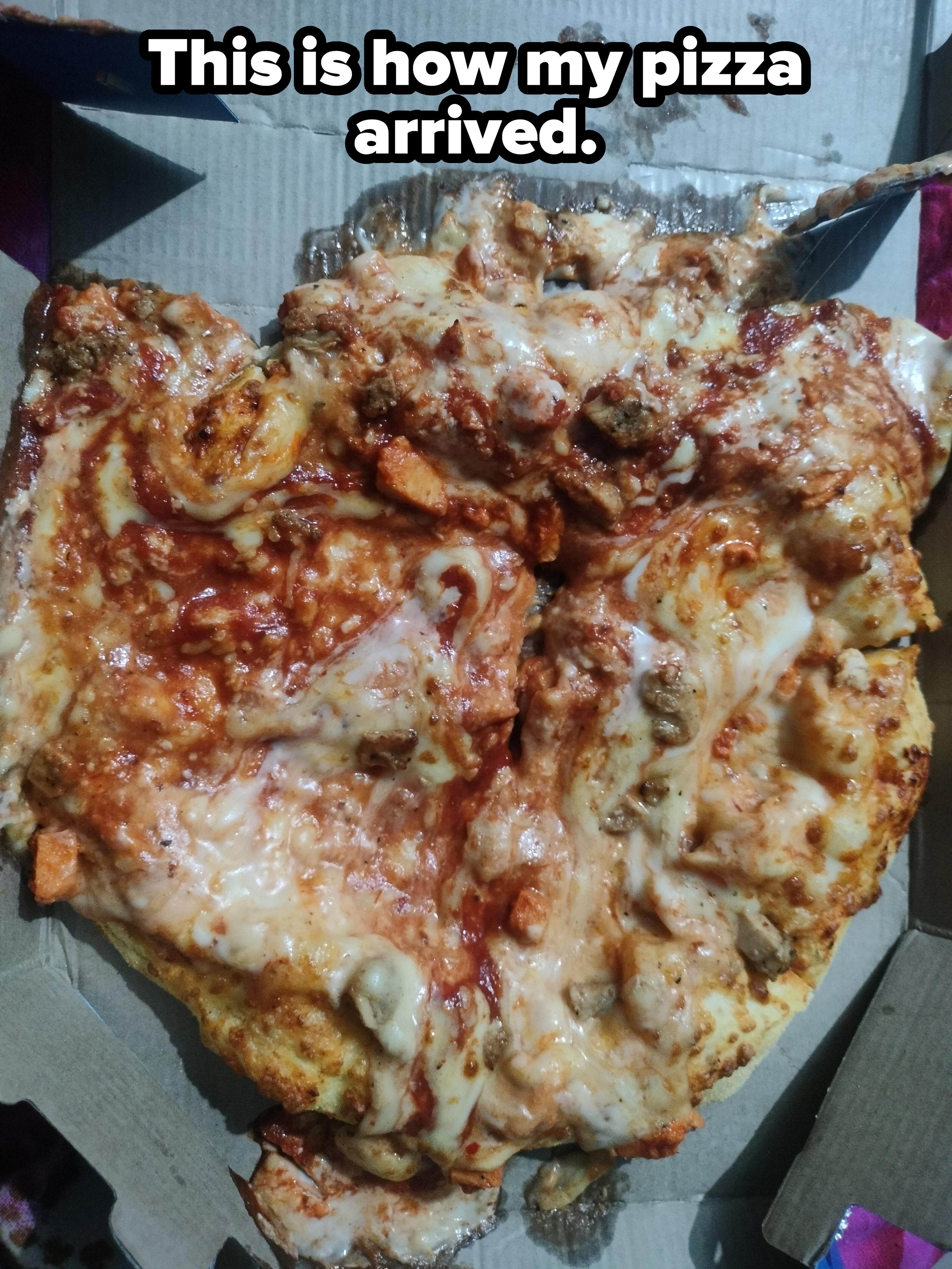 Pizza with a variety of toppings including melted cheese, sausage, and veggies on a thin crust, partially sliced in an open box