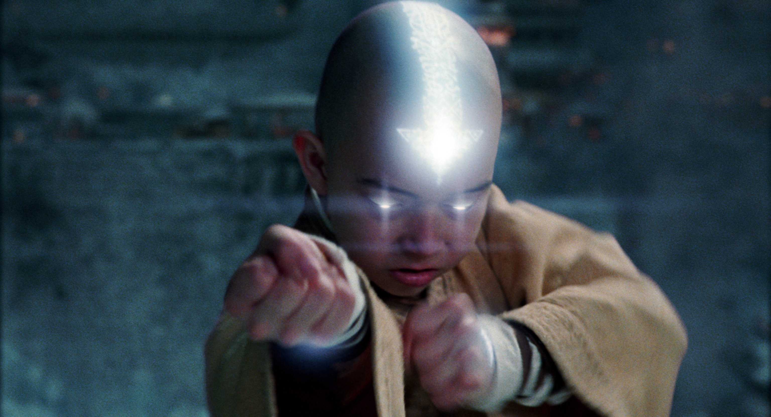 Aang, with a glowing arrow on his head, is bending with his fists