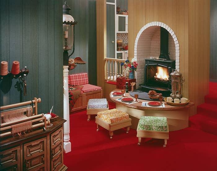 Cozy 1970s living room with a retro fireplace, patterned seating, and a warm, inviting atmosphere, highlighting vintage home decor styles