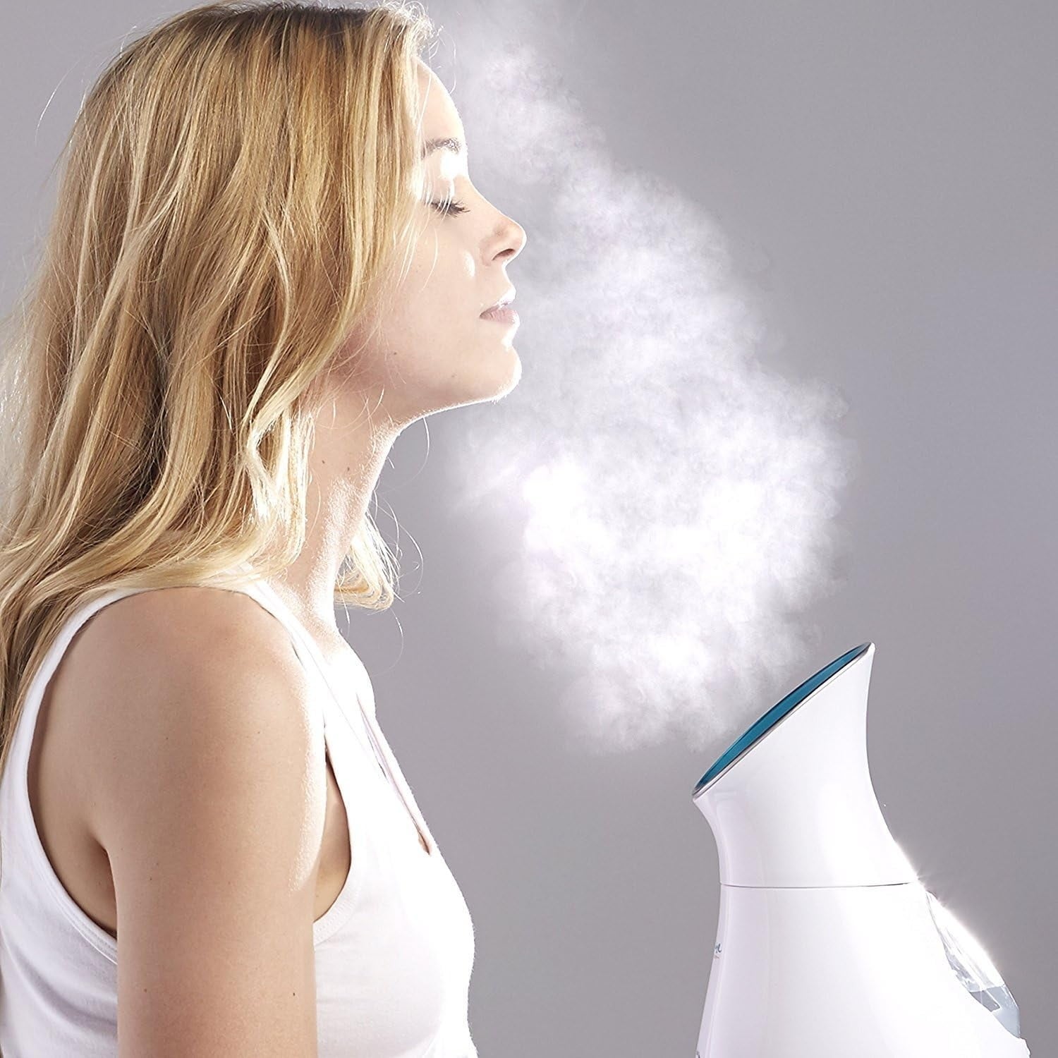 A exemplary  uses a facial steamer, eyes closed, enjoying spa-like attraction    astatine  home