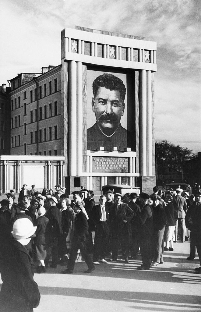 Heavy artillery on parade during a review of the Moscow Garrison troops during the May Day celebrations in Red Square, passing posters of Lenin and Stalin