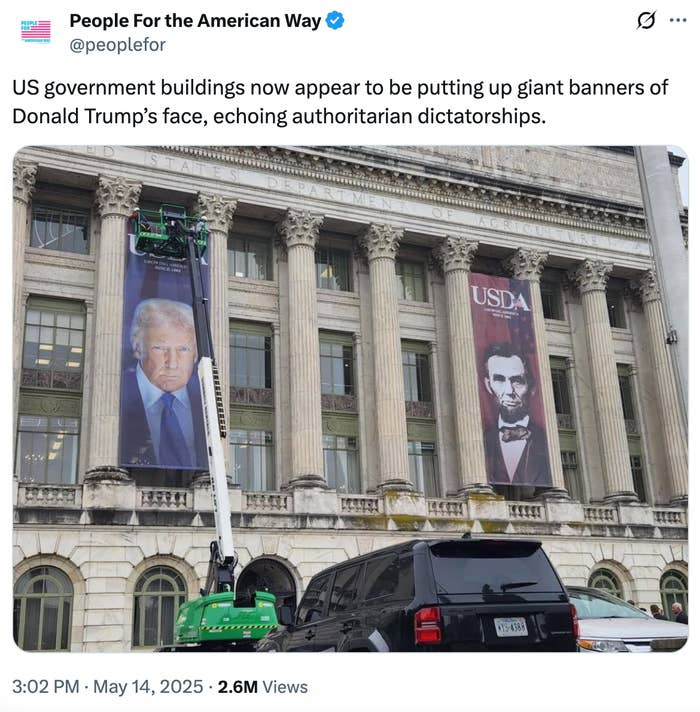 Photo of a government building with large banners of Donald Trump and Abraham Lincoln on the facade. Construction equipment is visible below