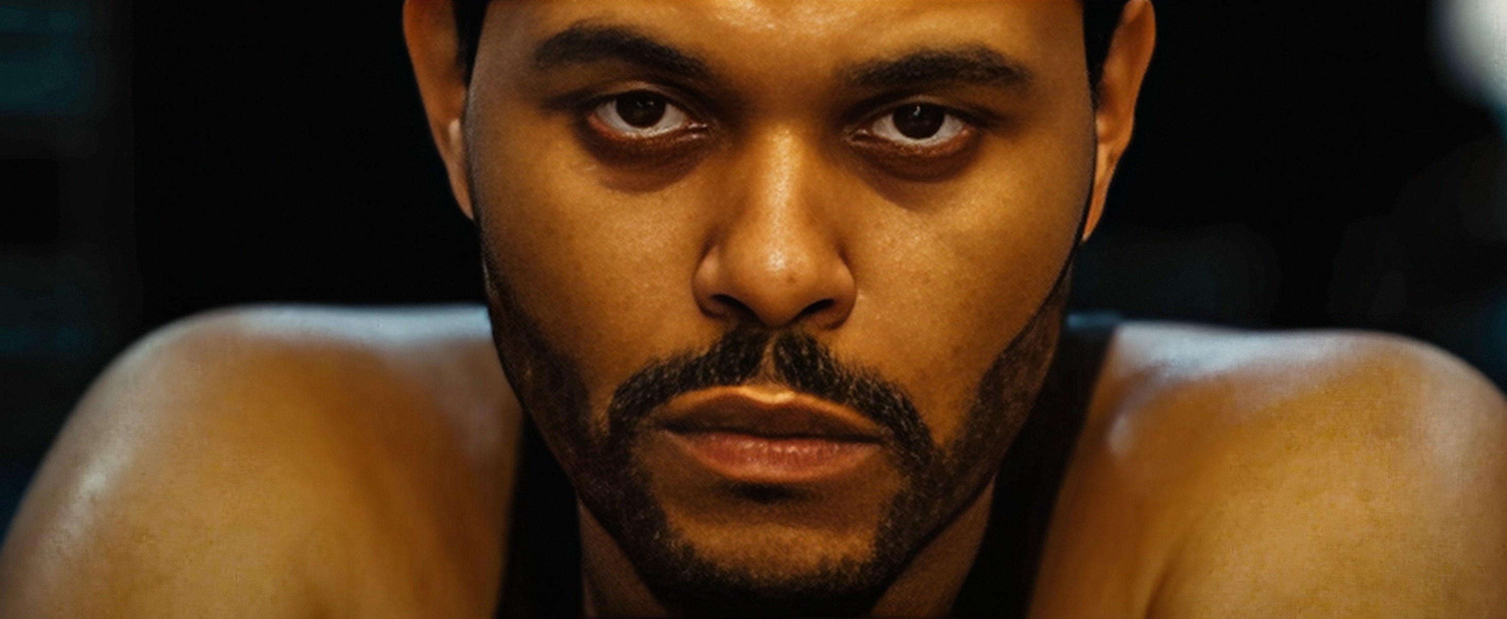 Person looking intensely at the camera, wearing a tank top. Suitable for a TV and movies article