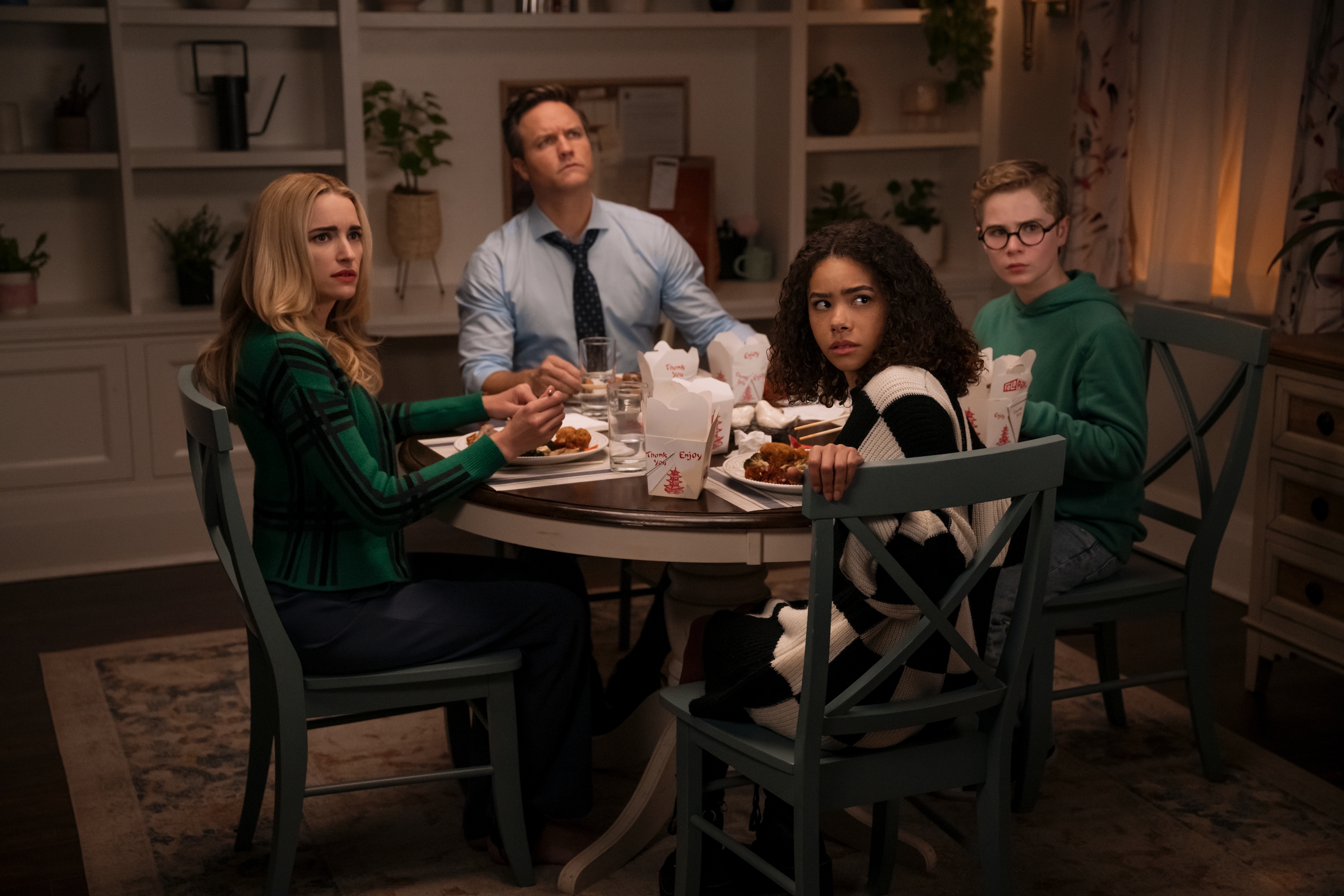 the Millers sitting at the dinner table and looking confused