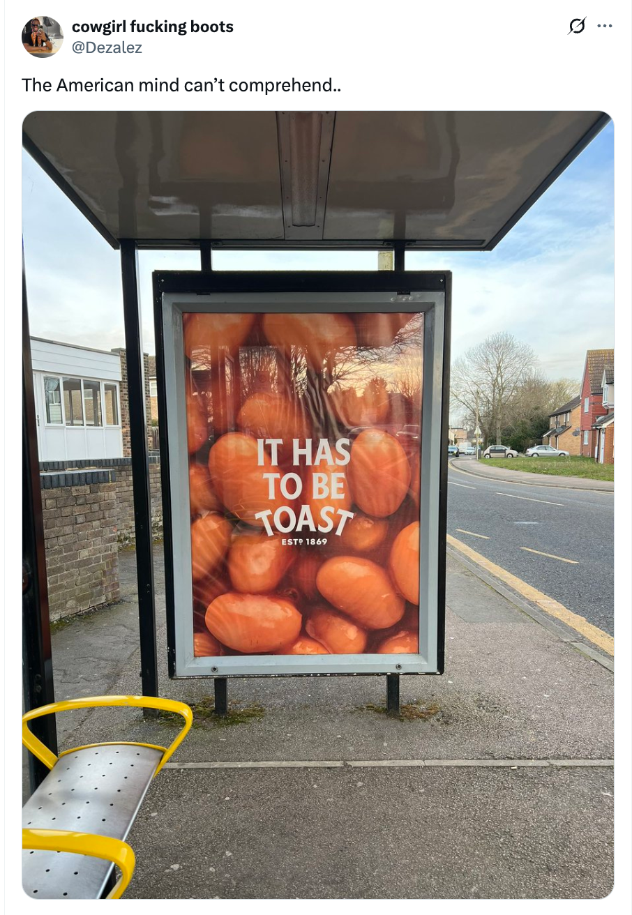 Bus stop ad with text: "It Has to Be Toast," featuring a background of toast slices. Caption above reads: "The American mind can't comprehend…"