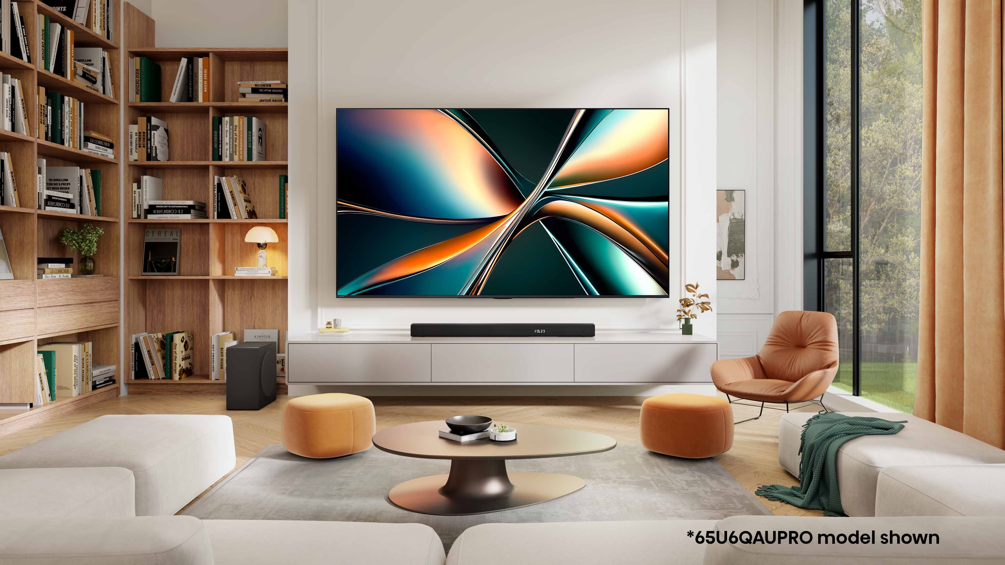 Modern living room with large flat-screen TV on a wall. Shelving unit, round coffee table, and chair complete the stylish, minimalist decor