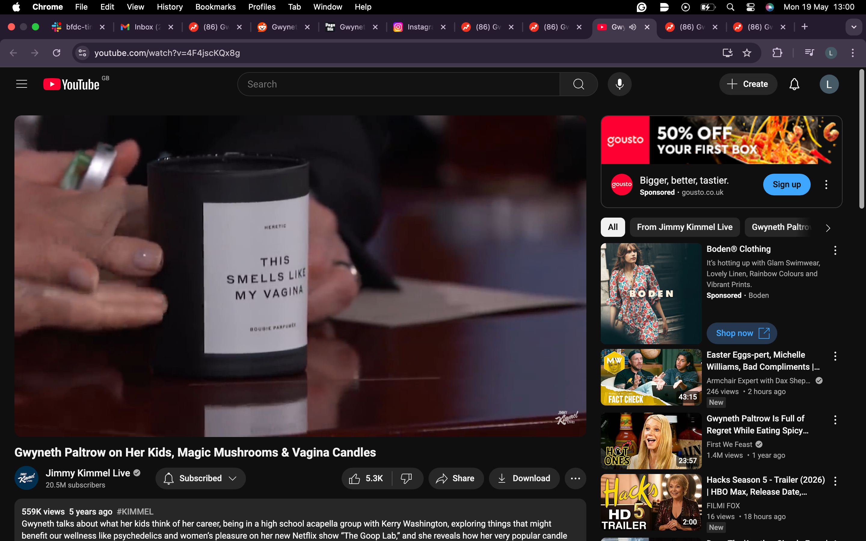 A candle labeled "This Smells Like My Vagina" on a table during an interview