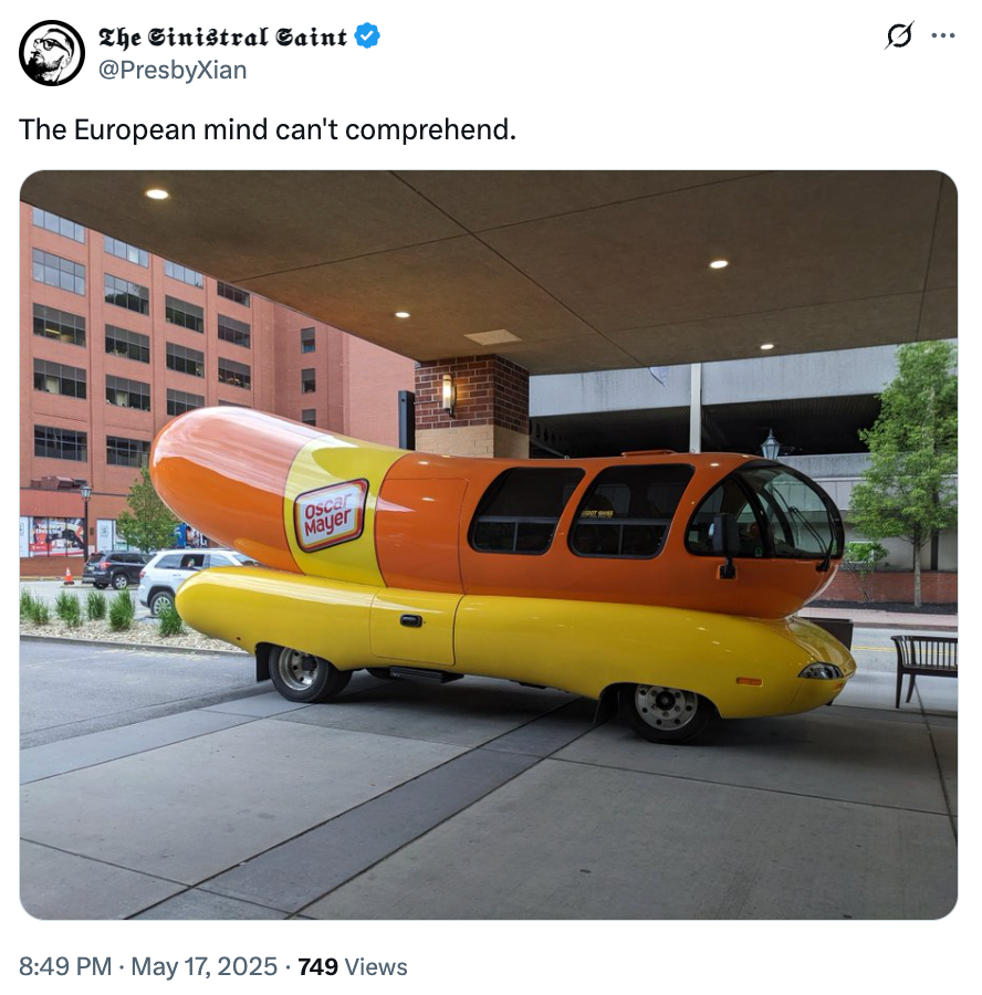 A Wienermobile parked under a building overhang with a humorous tweet about European confusion