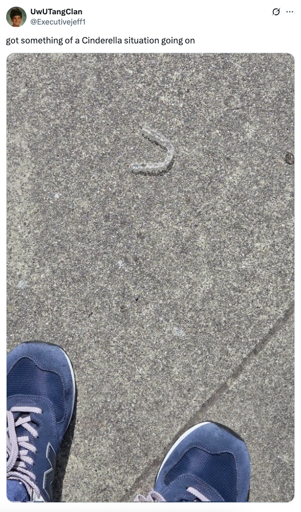 Blue sneakers near a lone glittery shoe on pavement, resembling a modern Cinderella scene