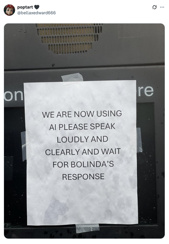 Sign taped to screen reads, "We are now using AI. Please speak loudly and clearly and wait for Bolinda’s response."