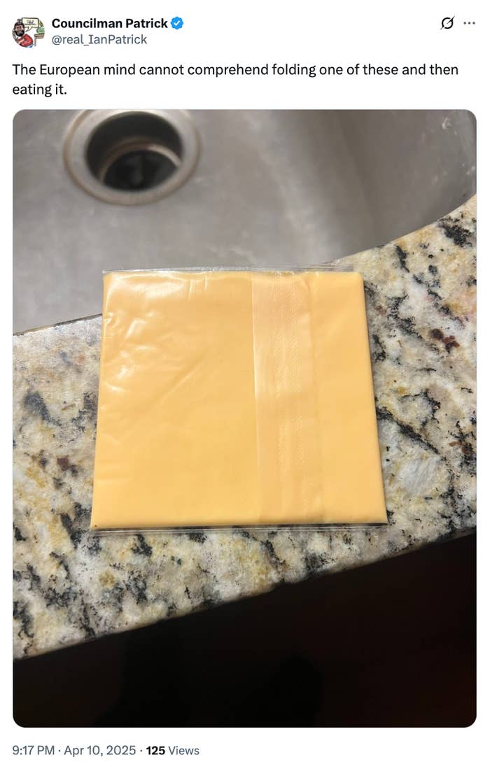 Slice of processed cheese on a counter near a sink, with a humorous caption about Europeans eating it