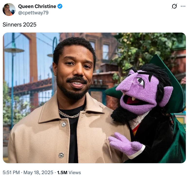 Person standing smiling next to a puppet in a cape and suit, on a set resembling a street scene. Tweet caption reads: "Sinners 2025"