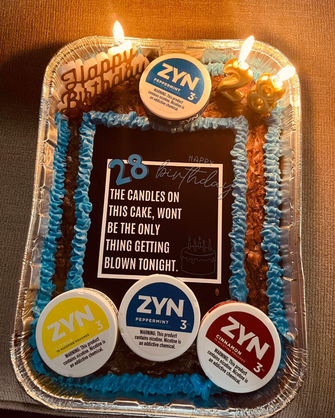 Birthday cake with candles and humorous text about candles being the only things blown tonight. Three ZYN nicotine pouches are displayed on the cake
