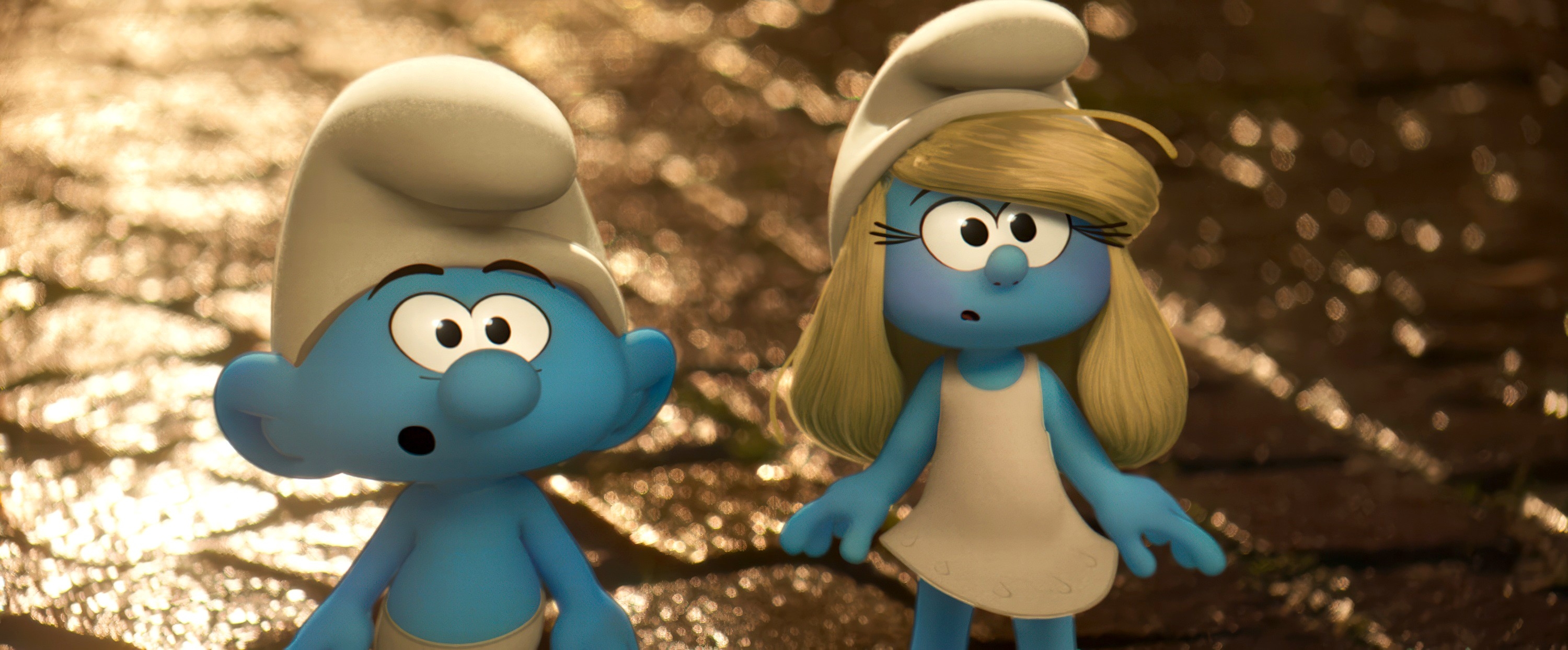 Two animated Smurf characters, a male and a female, stand with surprised expressions on a cobblestone pathway