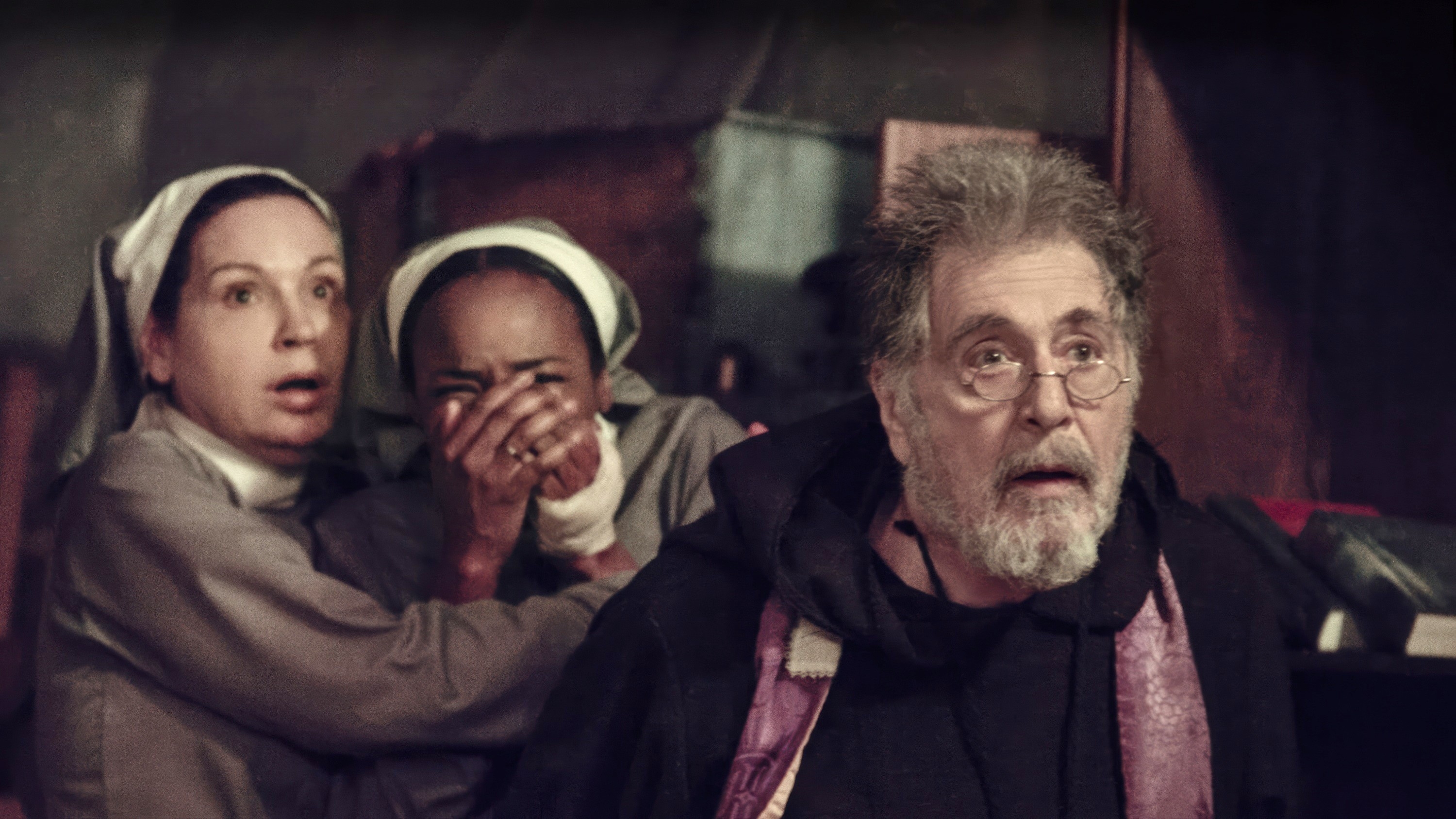 Three actors dressed as nuns and a shocked monk in a dramatic scene from a film set