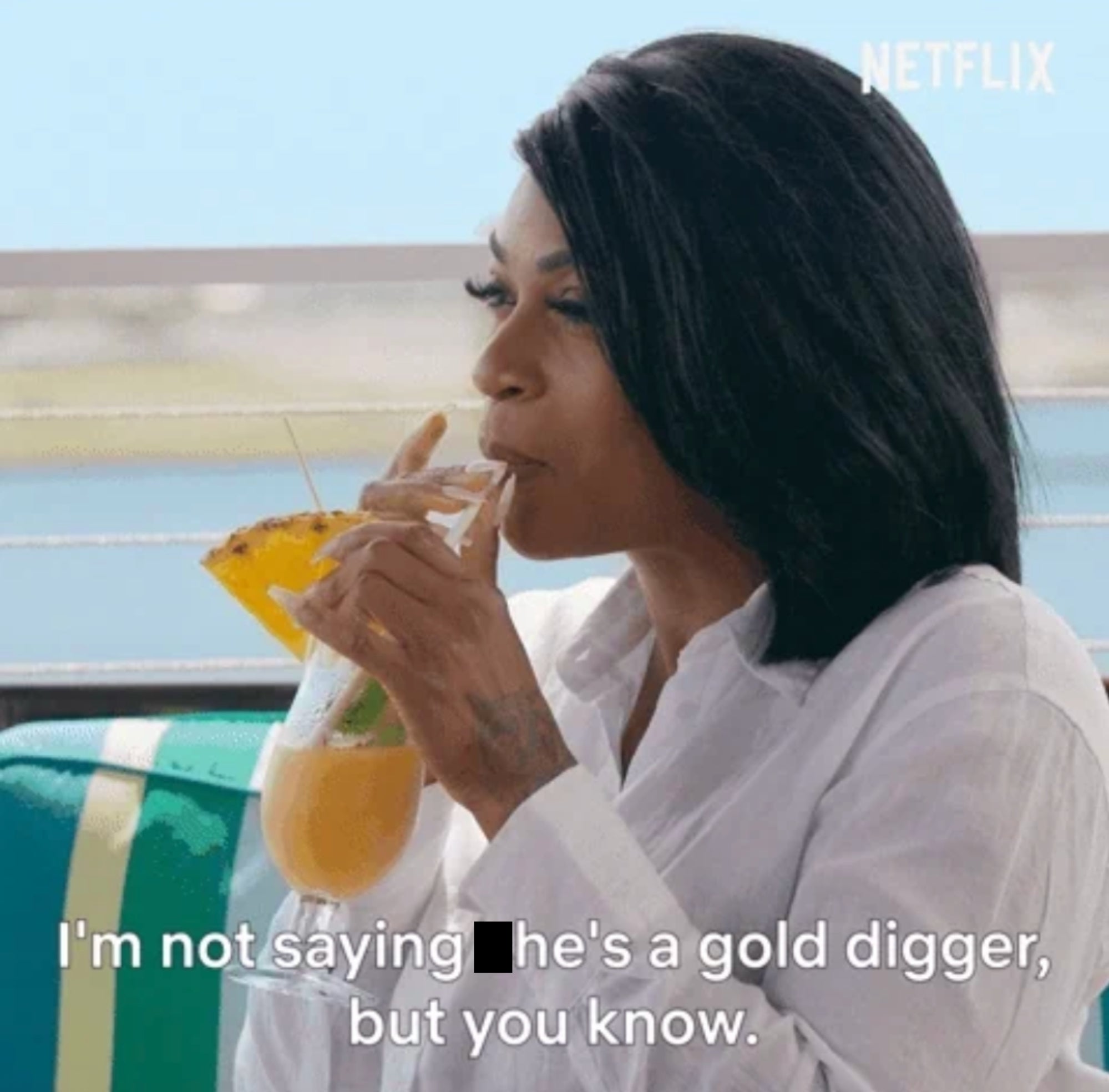 Person sipping a tropical drink while grinning. Subtitle reads: "I'm not saying she's a gold digger, but you know."