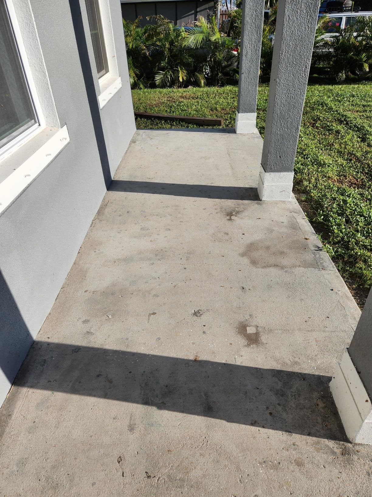 Concrete structure  with 2  columns, adjacent to a location   exterior. Grass and shrubs are disposable   successful  the background