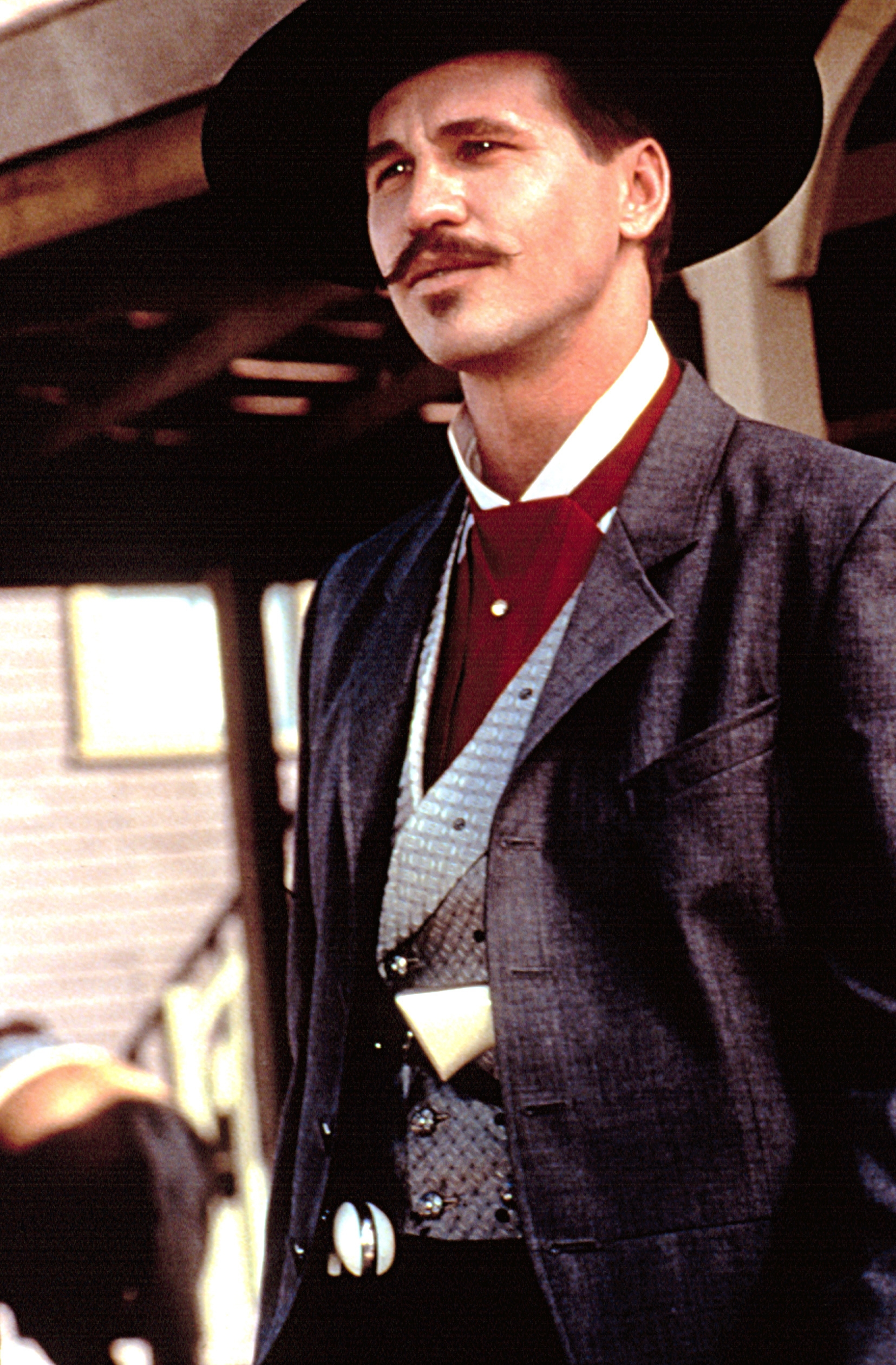 Person in a wide-brimmed hat and Western-style jacket with a vest, embodying a classic cowboy look