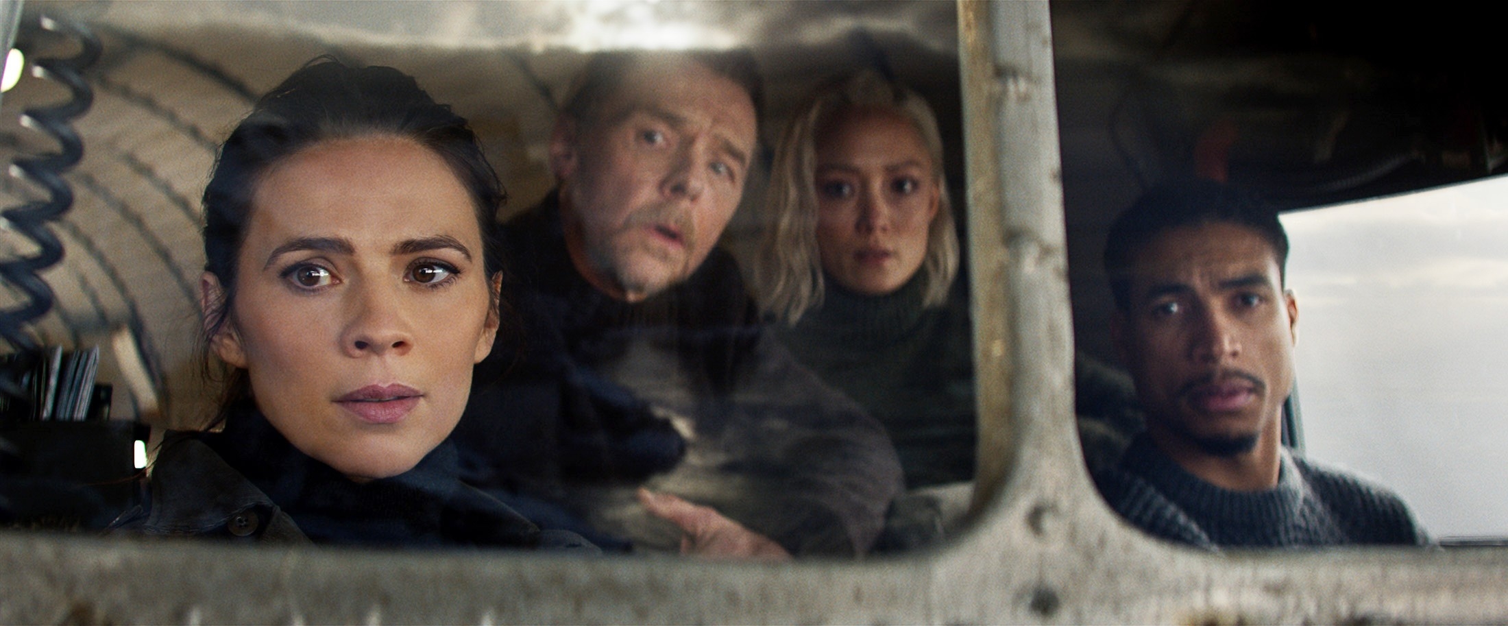 Grace, Benji, Paris, and Theo sitting in a plane looking out a window in a scene from "The Final Reckoning"
