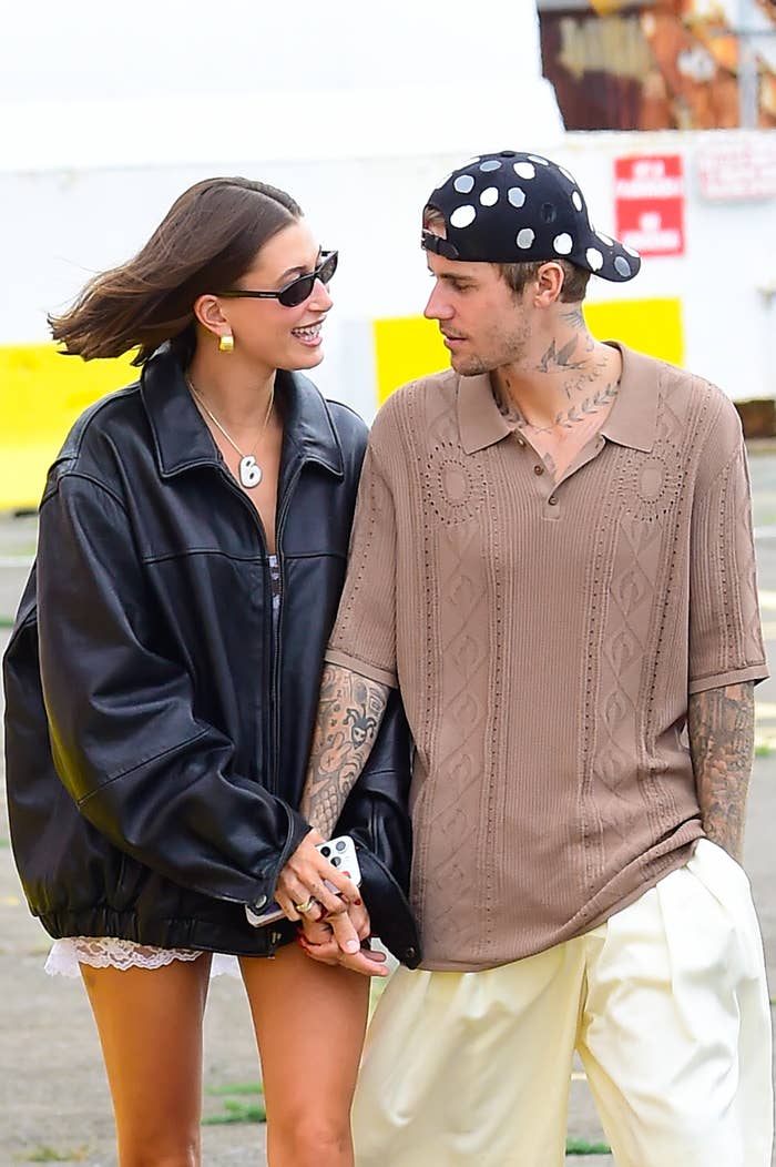 Hailey Bieber and Justin Bieber holding hands and walking outdoors