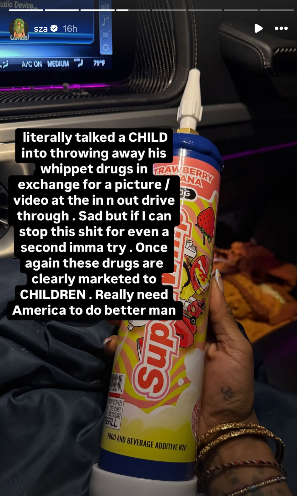 A hand holding a large can of whipped cream in a car. Overlaid text criticizes the marketing of whipped cream canisters to children