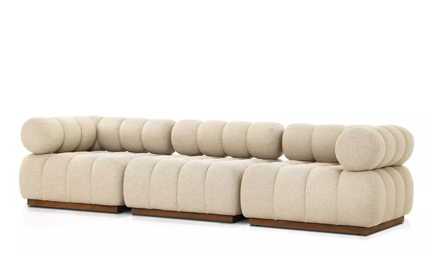 A modular beige sofa with rounded cushions and wooden base, ideal for modern living spaces